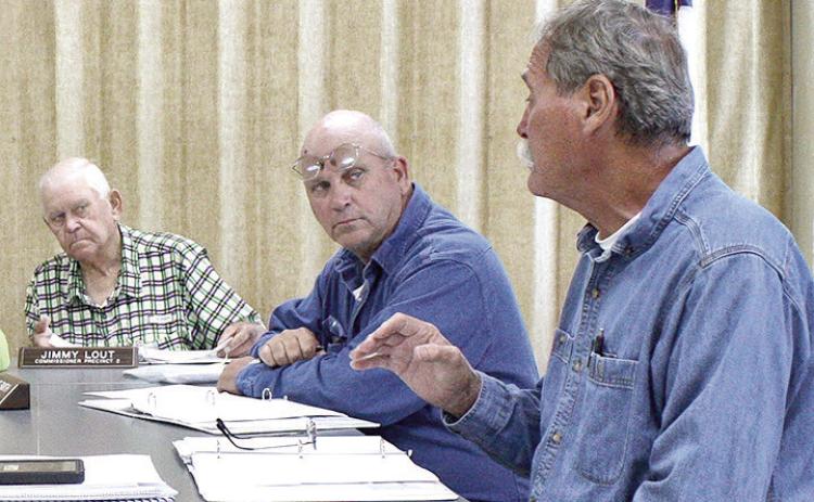 Commissioners (left to right) Jimmy Lout and Stevie Smith listen as Commissioner Tom Bellmyer adds to the discussion on the purchase of sheriff’s department vehicles at last week’s meeting. David Danley | The Light and Champion