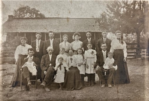 Edmund N. and Mary M. Sparks with their six sons and one daughter and their families in front of the Sparks home in Byfield.