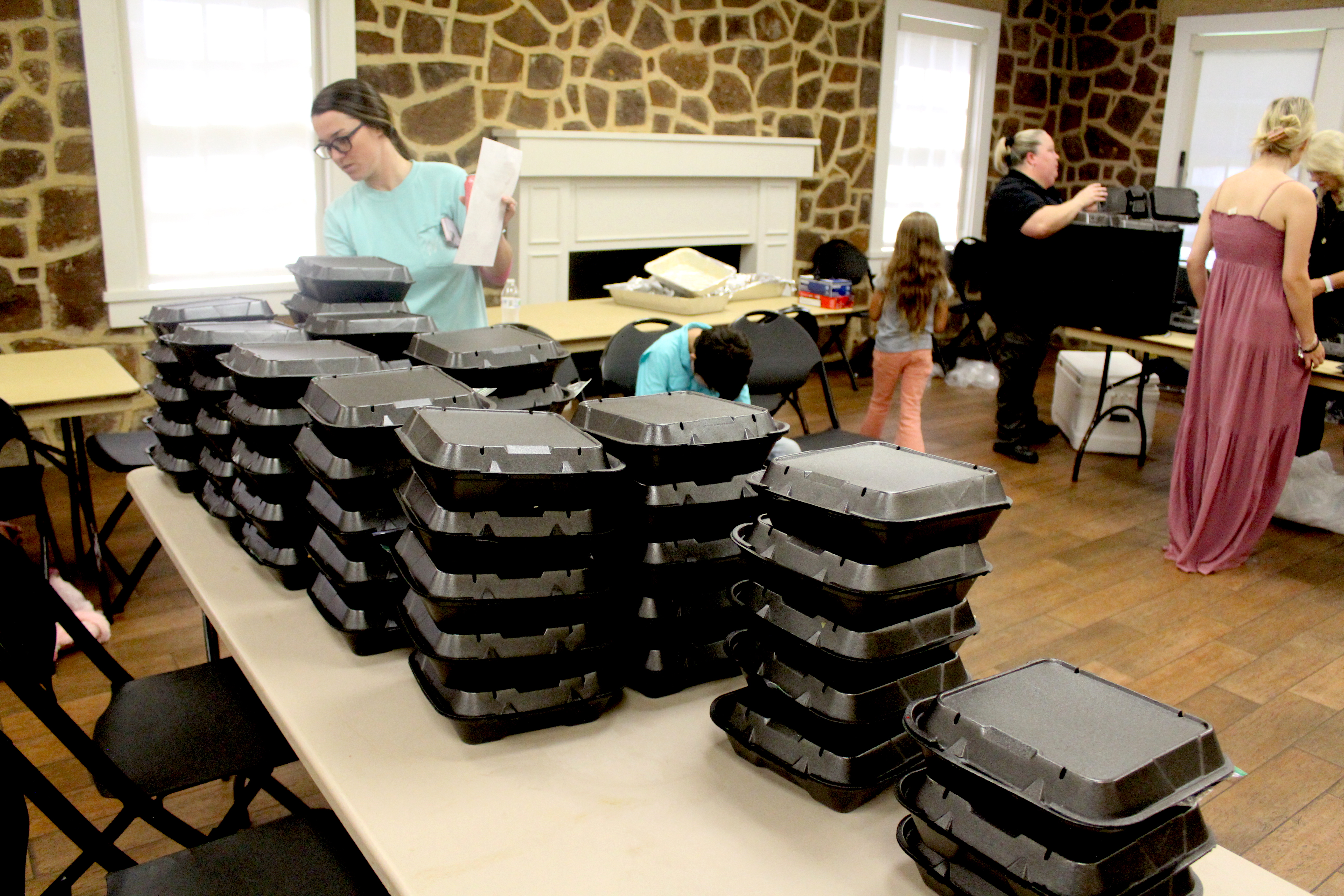 Organizers of the fundraising event prepare BBQ chicken plates for Battle of the Badges.