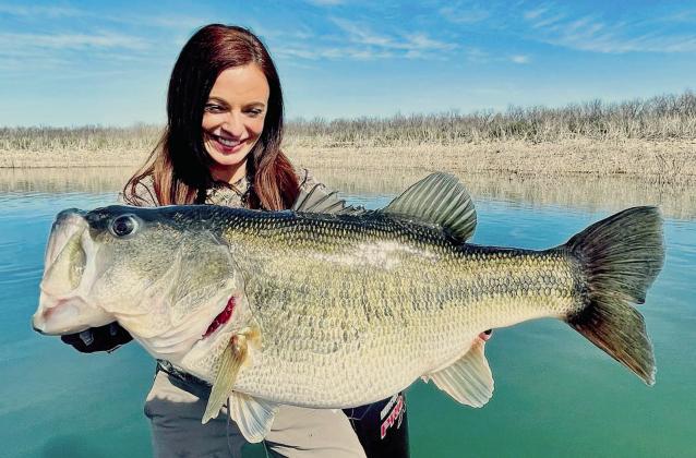 Lady angler Lea Anne Powell of Lake Jackson displays the 12- pound, 3-ounce bass she caught in February at Lake O.H. Ivie. Powell, who caught the fish on spinning rod, has submitted an application to the International Game Fish Association to have the fish certified as a 12-pound line class world record. (Courtesy Photo/Dalton Smith)
