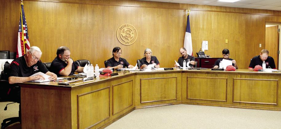 its Monday meeting. The Shelbyville ISD Board of Trustees reviews the districtMs monthly nancial report during