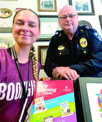 “Book Girl” snapped a photo with Center Police Captain Jeremy Bittick Monday, August 14 after he purchased educational books for his grandchildren.