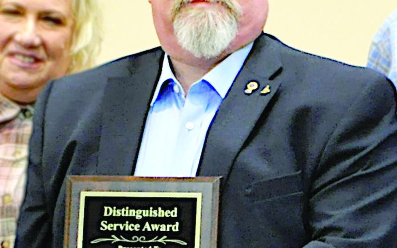 Roger Doyle pictured with his Distinguished Service Award. Zack Clark | The Light and Champion