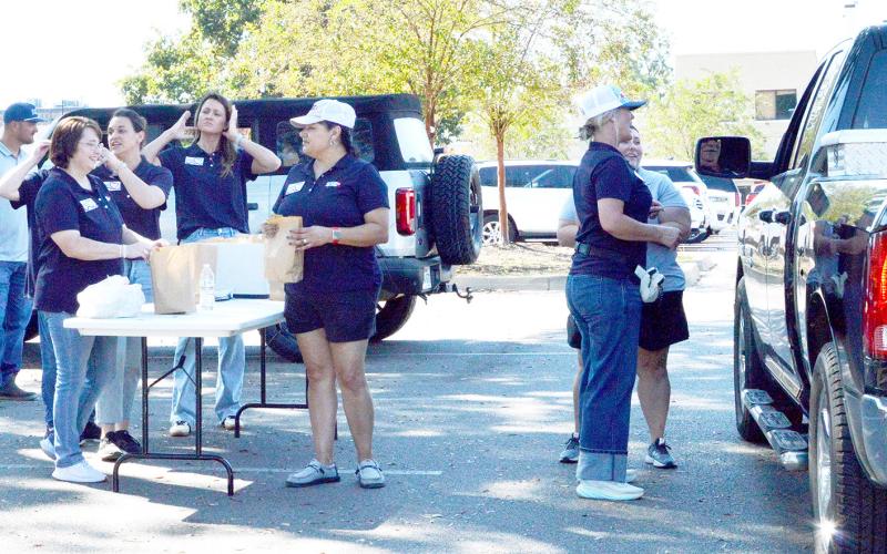 On Monday, Oct. 13, Shelby Savings Banks along with support from BOM Bank, Farmers State Bank, Sabine State Bank and Austin Bank, collaborated to offer $10 hamburger meals for the Texas Banks Community Day of Service. They set up on the Center square with a large grill and a dedicated team preparing food for pickup and delivery. All proceeds from the meal will go directly to Boo’s Battle Fund, which supports individuals and families as they fight their battle with cancer. Zack Clark | Light and Champion