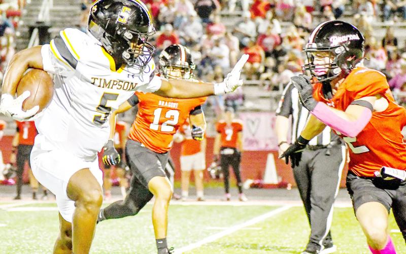 Jeffrey Richardson of the Timpson Bears prepares to give a rude reception to Shelbyville’s Hunter Harvey in the two teams’ cross-county clash last Friday night. Timpson ISD | Light and Champion