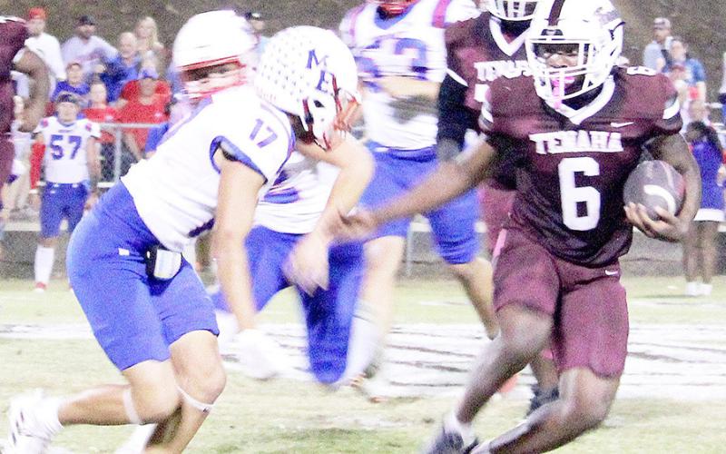 Tenaha’s Kori Miles makes a cut to the outside in an effort to evade a Mt. Enterprise defender closing in on him in last Friday’s game that got away from the Tigers by a score of 56-22. Tracy J. Tutt | Light and Champion