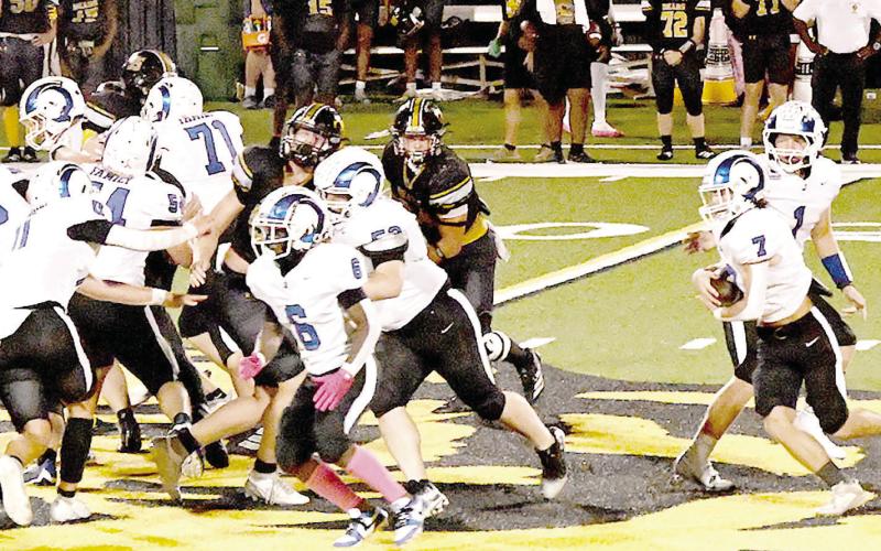 The Joaquin Rams’ Zach Kelley (7) takes a handoff from quarterback Trenton Runnels (1) while Amarion Wilson (6) leads the way upfield in action against the Timpson Bears last week. Kelsi Wood | JHS