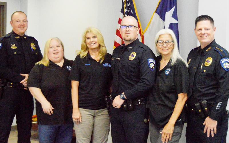 Members of the Center Police Department gathered this past Friday to witness the promotion of three long-term dispatchers and a patrol officer. (Left to right) Lieutenant Andy Williams, Amy Lindley, Donna Dugger, Detective Garret Rocchi, Charlene Jackson, and Chief Ricky King. Zack Clark | Light and Champion