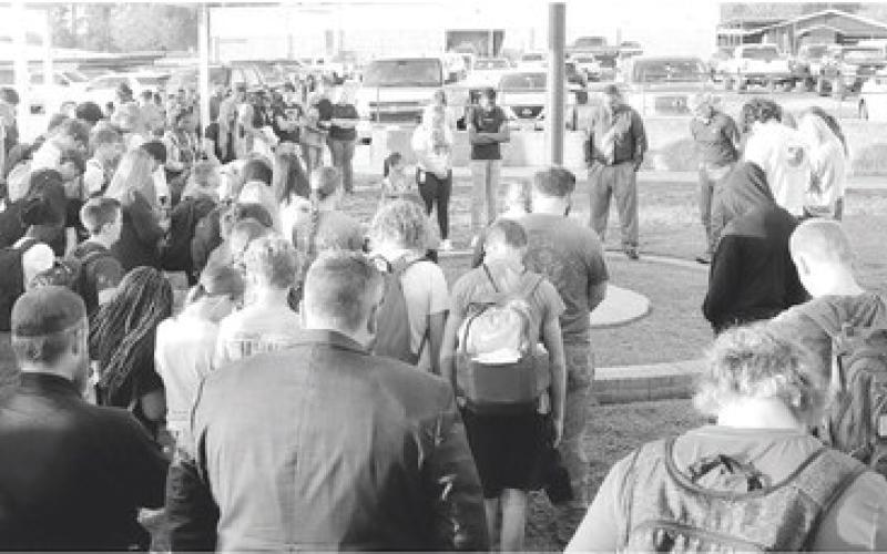 Faculty, students and community members gathered at the Shelbyville ISD flagpole Wednesday morning to pray for the school and community. (Photo submitted by Debbie Gilchrist)