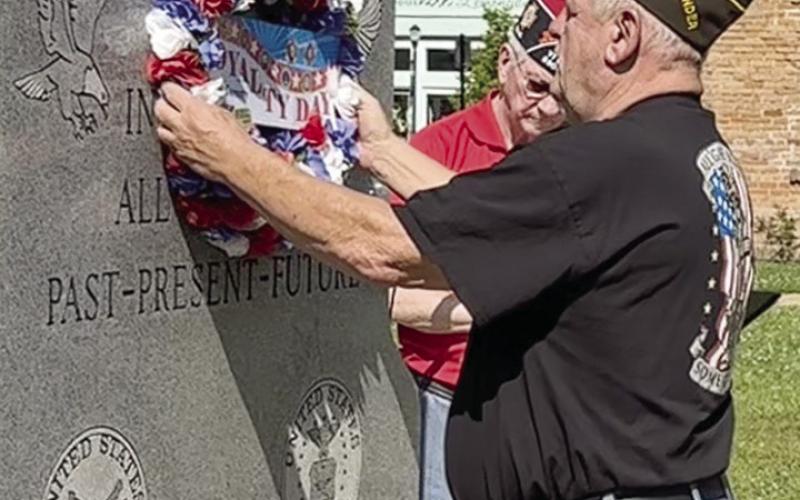 Post 8904 Sr. Vice Mike Wulf places the Loyalty Day wreath on the Veteran’s Memorial at Loyalty Day remembrance. Leon Aldridge | The Light and Champion