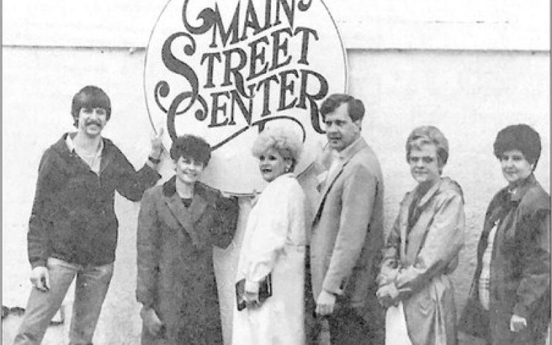 GETTING READY - Members of the Main Street subcommittee charged with preparation for the kick-off celebration March 9 featuring a visit by Texas First Lady Rita Clements include (from left to right) Rob Payne, Main Street Manager Charlene Burke, Sandra Boles, David Chadwick, Chairman Frances Oates and Jean Minor.They are displaying a sign with the Center Main Street logo which will be displayed on the bandstand on the courthouse lawn. (Staff photo by Candace Velvin)