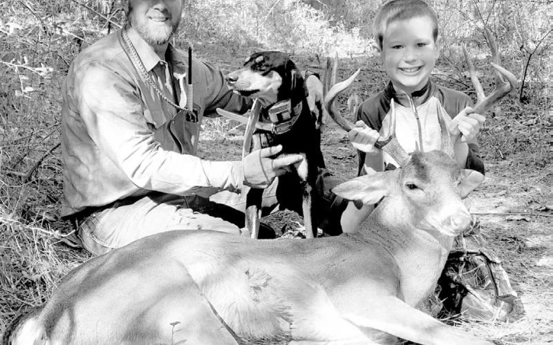 Jeff Glende (left) and his hound/cur mix “Dago,” have teamed up to recover dozens of bucks for Texas and Louisiana deer hunters. Like many dog handlers, Glende loves seeing the smile on a youngster’s face when they learn a lost deer has been found. (Courtesy Photo, Jeff Glende)