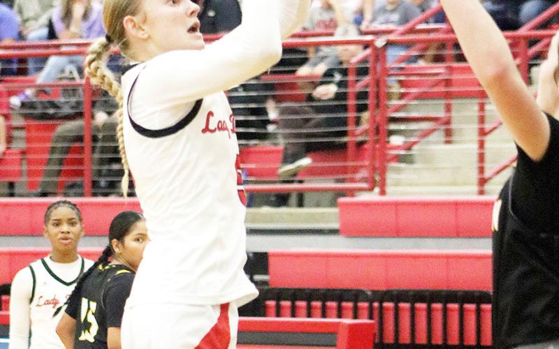 Cori Lawson makes a jump shot in the Shelbyville girls’ 32-30 win over Woden.