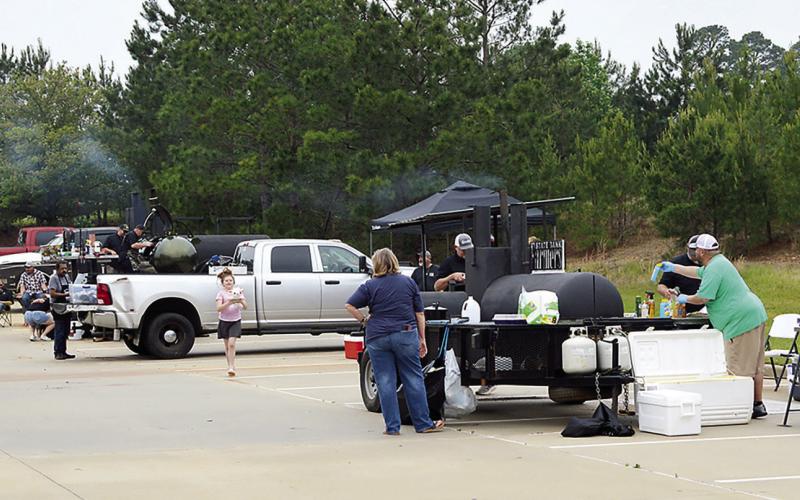 Contestants in the 2026 Annual Grill Fest watch over their entries as the competition draws closer to its conclusion. Real Smoke BBQ from Tenaha with Duane Anderson as head cook came out as the Grand Champion in the event. David Danley | Light and Champion