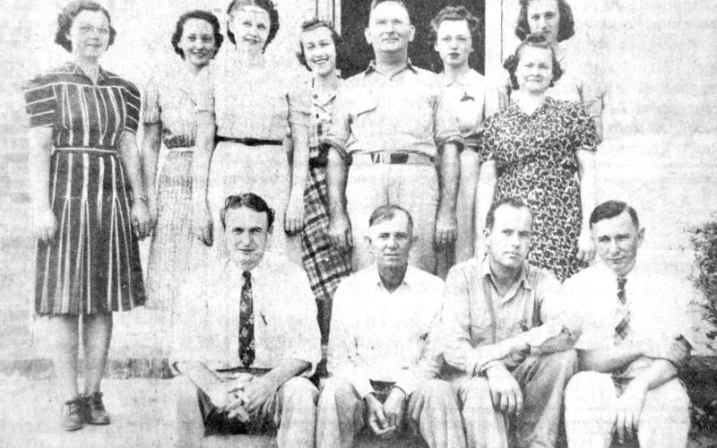 This June 1939 photo shows employees of the Agriculture Adjustment Administration posing on the porch of the historic 1885 jail building, where the AAA offices were housed. Employees who posed for the picture were (front, from left) Jim Swanzy, John Bowers, Sanders Liles and Jim Brooks. Standing (from left) are Helen Baldwin, Rena Norris, Merle Davis, Bess Johnson, R.H. Dominy, head of the local office, and Miss Burgess and Miss Enmon.