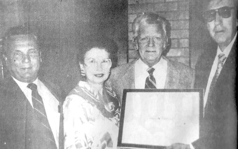 JIM FORBES RECEIVES NATIONAL HONOR — Jim Forbes of Center recently received the Campanius Holm Award from the National Weather Service in Shreveport, La. Presenting the award was Ernest Ethridge of the National Weather Service Office and Malcom Moreau, cooperative program manager. Pictured (from left) are Malcom Moreau, Mrs. Ann Forbes, Jim Forbes and Ernest Ethridge. (Submitted photo)