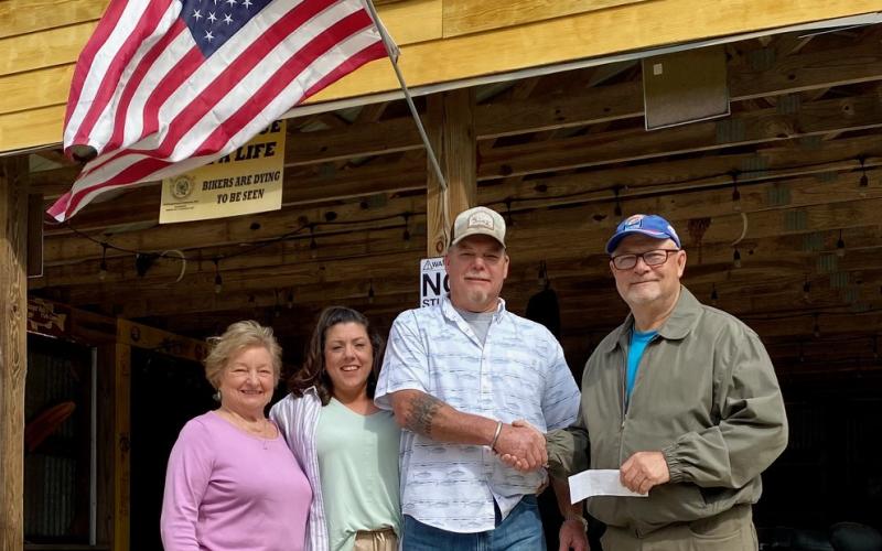Pictured presenting a check to TBLA, the new owners of Gilligan’s - Jennifer and Derek Nichols (center), with BU Prize Coordinator Linda Ward, and TBLA President Gary Moore.