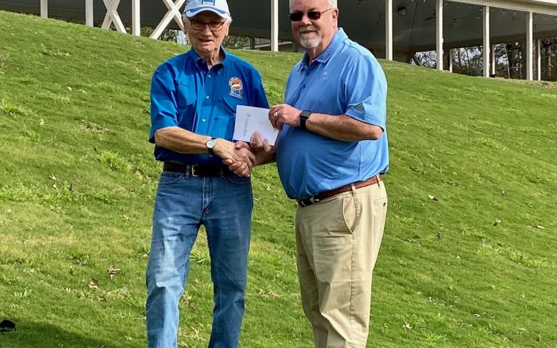 Cypress Bend General Manager Randy Rolland (right) presents TBLA BU Chair Ted Dove with certificates for a golf one year membership to the newly renovated golf course and two golf/accommodation weekend packages that will be auctioned at the Bass Unlimited Banquet.