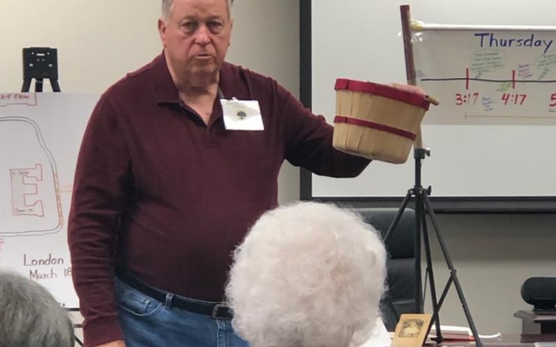 Jim Ross presenting a peach basket in relation to the peach baskets used during the London tragedy.