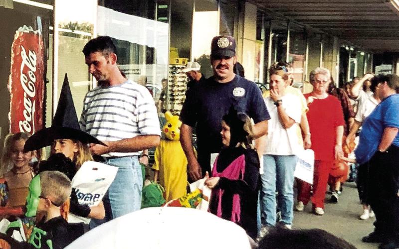 Trick or treaters on the downtown Center Square were making the rounds in droves when merchants invited little ghosts and goblins to come in several years ago. Recognizable is the storefront of what was once Perry Brothers, later a dollar store and more recently, Nettie’s Nook and Center Antiques. According to information on the back of the photo, trick or treating on the square captured in the picture took place on November 30, 2000. (Photo courtesy of Ann Bowen)
