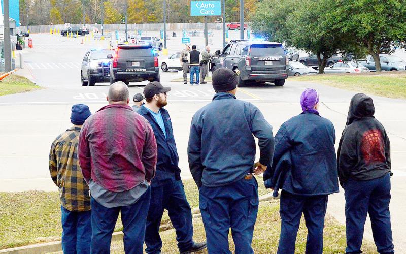 Walmart employees gather across the street from the store after being evacuated from the building after a bomb threat was received Thursday morning, Dec. 18. David Danley | Light and Champion