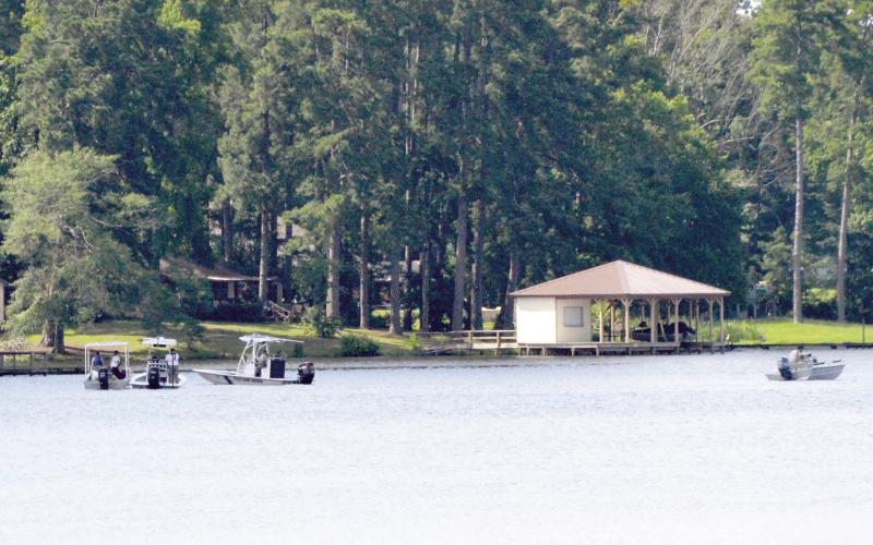 Texas game wardens, along with local law enforcement officers and volunteers, search an area of Lake Timpson where a drowning victim’s kayak capsized. David Danley | Light and Champion