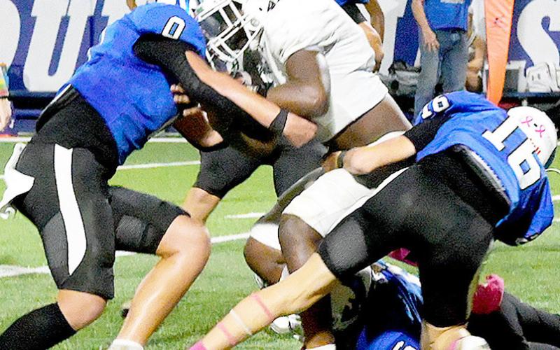 Kason Stanaland (0), Mason Fults (16) and Amarion Wilson (6) gang up to take down a Hemphill runner during Joaquin’s Homecoming game last Friday night. Kelsi Wood, JHS | Light and Champion