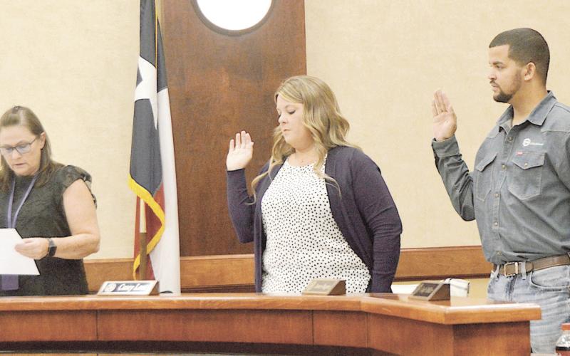 Joyce Permenter, CISD Superintendent’s Secretary, administers the oath of office to (from left) Casey Lout, James Ragan and Cody Miller. Also sworn in was Josh Burns. David Danley | Light and Champion