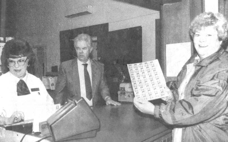 JoAnn Davis of Center was first in line at the Center Post Office Friday to purchase sheets of the special Elvis Presley stamp.Assisting her were Shirlynn Harbison and Postmaster Jim Cunningham.The stamps went on sale Jan.8 (Presley’s birthday) at post offices across the country with Elvis fans waiting. With close to 500,000 million of the stamps printed, postal customers wanting the stamps shouldn’t be disappointed. (Staff photo by Candace Velvin)