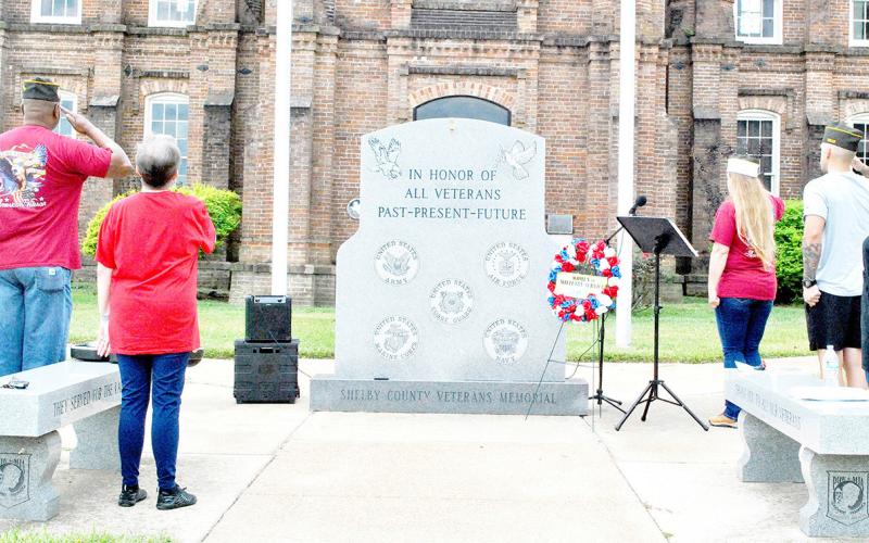 Members of VFW Post 8904 and Auxiliary offer a salute during the post’s observance of Women in Service Day. Zack Clark | Light and Champion