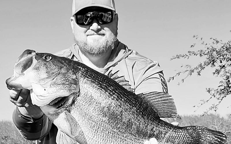 Fishing guide Austin Miles with the 16.04-pound Legacy Lunker he reeled in at Purtis Creek State Park Lake. Miles’ bass is the No. 27 heaviest Texas bass of all-time. Photo courtesy of Austin Miles