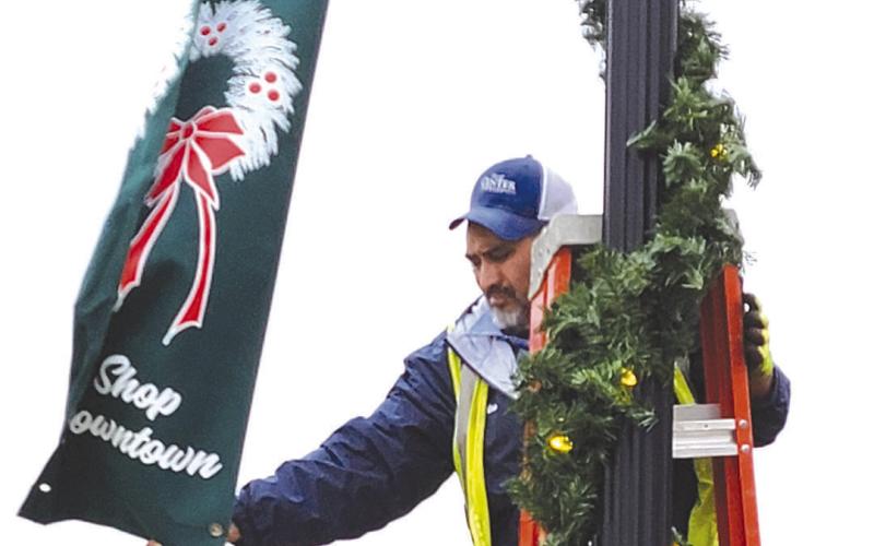 Decorations abound the Shelby County Historic Courthosue Square as crews from the City of Center don lightpoles with holiday banners, large holiday displays and Christmas cheer as the nights become shorter, Santa is getting closer. Dennis Phillips | The Light and Champion