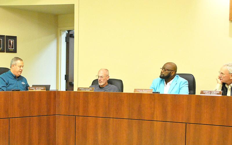 Center City Manager Chad Nehring informs the city council about bids received to replace the roofs on the city hall and library buildings. Lisa White | Light and Champion