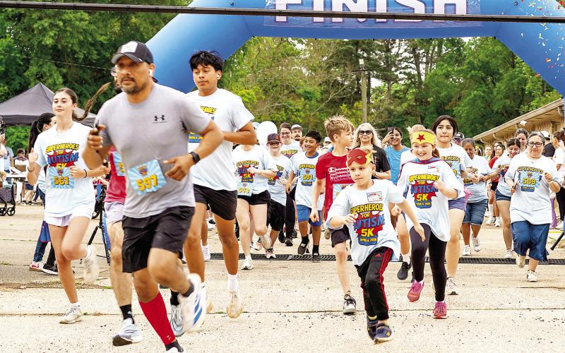 Participants in the first annual Superheroes for Autism 5K race and walk burst across the starting line in the parking lot of Center Missionary Baptist Church. The event was staged to raise awareness of autism and as a fundraiser for Uniting Pieces, a group organized to offer support and resources to families with children with autism. See back page for more pictures. Abram Morales | Light and Champion
