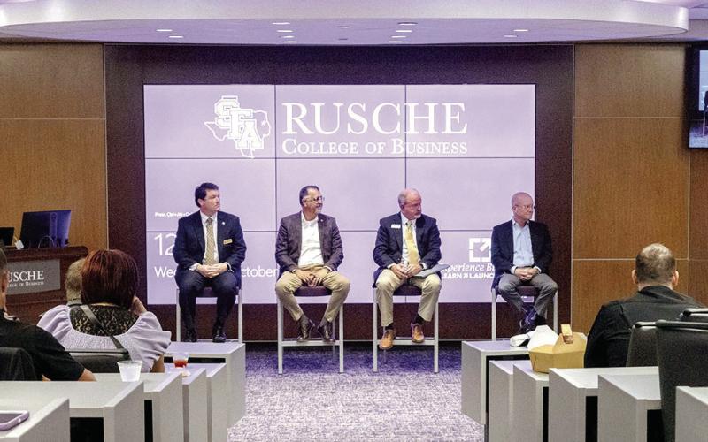 Panel moderator Judy Larson Olson, standing, former Stephen F.Austin State University regent and senior vice president at Woodforest National Bank in The Woodlands, leads the panel discussion “Why Choose Banking” at SFA’s “Bank on Your Future” career exploration day.