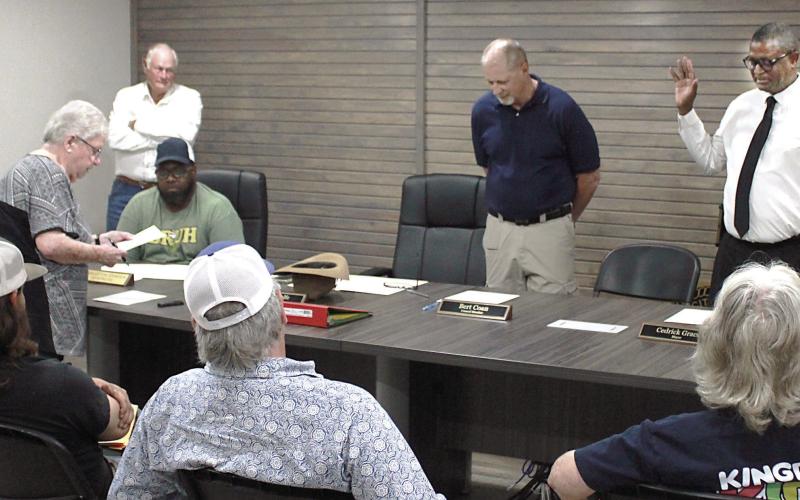 Newly-elected mayor Cedric Grace (right) and council member Bert Coan (center) are sworn in at the May 12 meeting of the Timpson city council. Incumbent Tammy Ramsey was sworn in to another term on the council, as well. Lisa White | Light and Champion