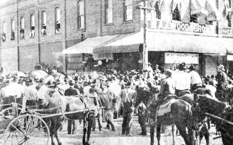 A.J. WOOD STORE 1900s AT CENTER – The A.J. Wood Brothers Store in Center was located in the Payne-Payne Building prior to 1915.This scene is one of the many visits made to Center by Buster Brown and his dog Tige. Note that Buster is standing under the awning and the crowd covered the area on Shelbyville Street and folks were upstairs in the building and no cars in sight! Photo courtesy of Lora Wood Rhein of Houston whose father was a partner in the business. (Photo cutline by Mattie Dellinger)