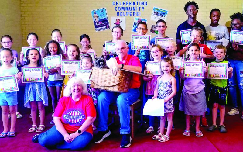 Roy and Sandra Davis smile with their six-week summer program attendees (Submitted photo)
