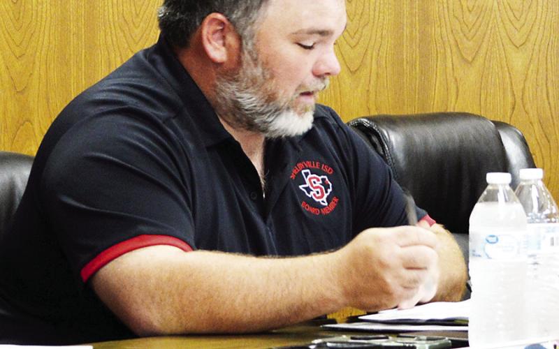 Shelbyville ISD Board of Trustees member Robbey Dutton makes a comment concerning the increase in employee health insurance premium contributions the board approved. David Danley | Light and Champion