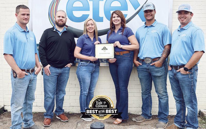 The Center team of Etex proudly display the Best of the Best certificate the company earned as Best Internet provider. Submitted | Light and Champion