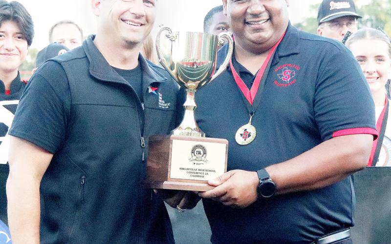 B.J. Muschalek of Texas Farm Bureau, (left) presents Shelbyville High School principal Mario Osby with the 2025 Lone Star Cup award in a ceremony held on Friday, Sept. 26. The Dragon Yearbook