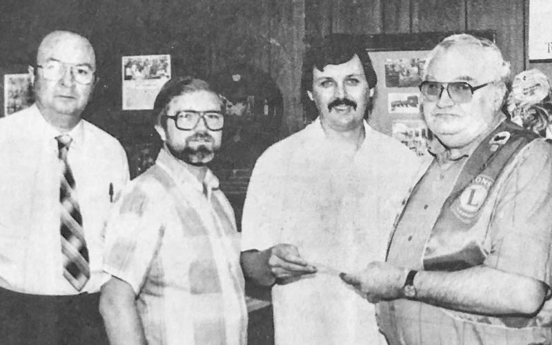 McGRUFF DONATION — Albert Axen (third from left) is among the sponsors of the McGruff puppet program conducted in Shelby by the Breakfast Lions Club. With him are (from left) Billy Magness, coordinator the Shelby County Co-op where several donated McGruff puppets are in use; Leroy Newman, secretary and Billy Clyde Duncan, president of the Breakfast Lions Club.The club is placing puppets at schools throughout Shelby Conty, recently taking some to Shelbyville.