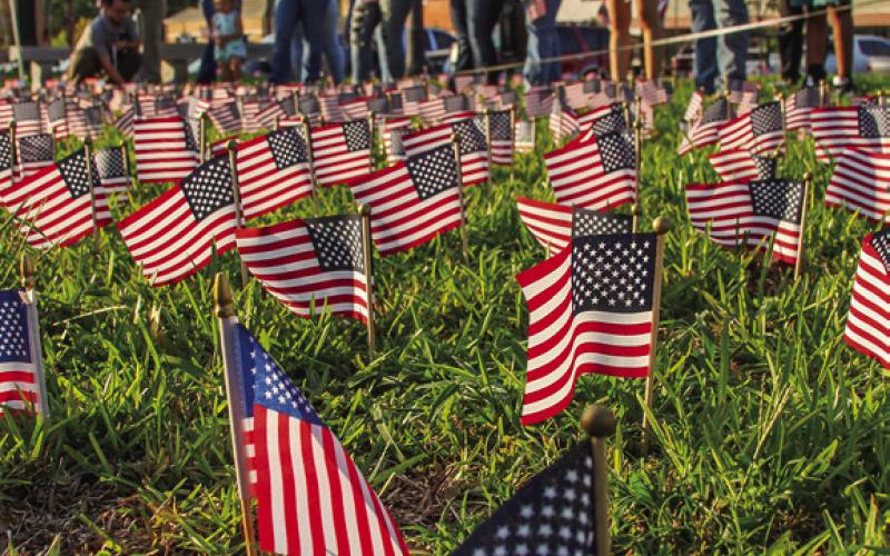 Next Gen and Junior Chamber students place flags for the 9/11 memorial at last years memorial. (Light and Champion file photo)