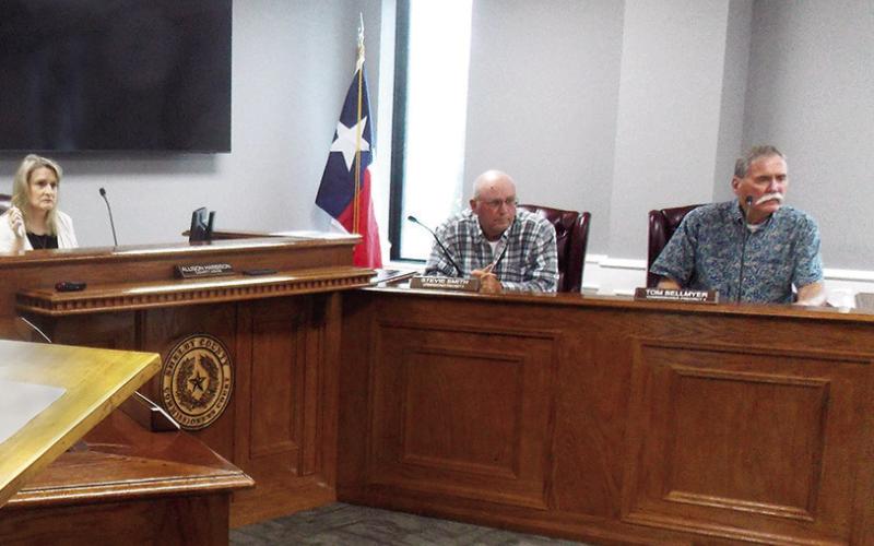 Commissioners Stevie Smith and Tom Bellmyer listen to a report from Sheriff Gerald Corbell concerning his department’s recent visit to the state Jail Commission. Zack Clark | Light and Champion