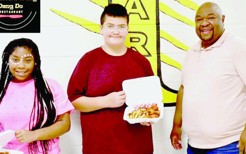 Johnson’s Wang Dang Do is set to donate two meals weekly to selected TMS students. Chris Knickleberry, Middle School Principal, presented the first winners Madyson Jones and Dakota Bright with their prizes. Submitted | Light and Champion