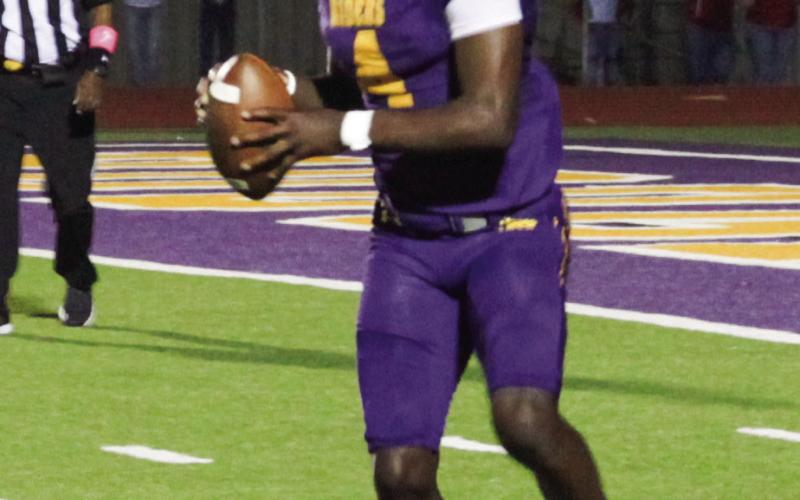 p Quarterback Emonte “Cash” Cross looks for a receiver. (Leon Aldridge photo/The Light and Champion)