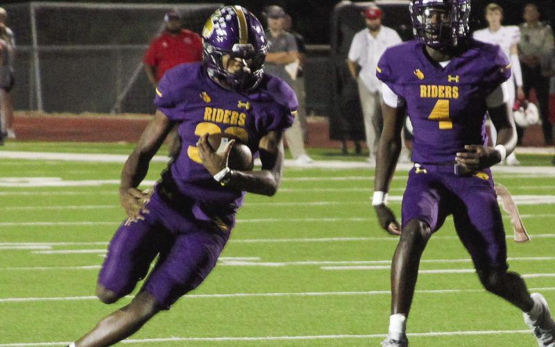 t Kaden Dixon (32) turns the corner after taking a handoff from Emonte “Cash” Cross (4) and looks for running room. (Leon Aldridge photo / The Light and Champion)