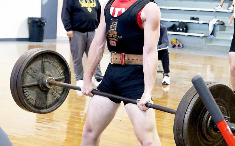 Hunter Harvey of the Shelbyville boys powerlifting team lifts in the LCQ meet held in West Sabine. Dragon Yearbook | Light and Champion