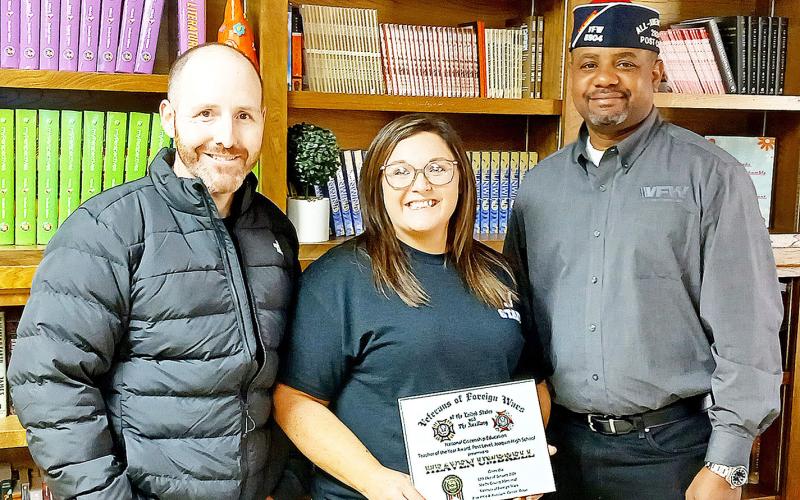 Joaquin High School teacher, Heaven Umbrell recently received her VFW Post 8904 Teacher of the Year award for 2025-2026. On Monday, Jan. 12, Post Commander Derrick Roberts (right) presented Umbrell with a framed certificate and a check for $200. Also on hand was Joaquin High School Principal Jonathan Jones. Submitted | Light and Champion