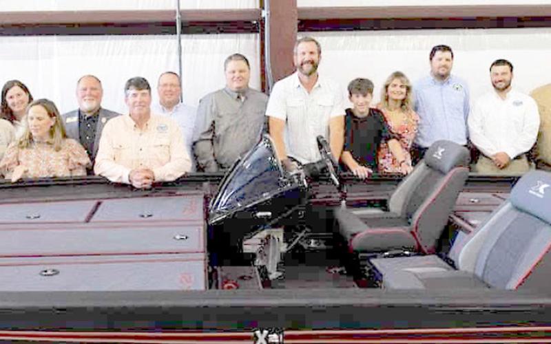 AGFC Commissioners and staff stand with Rory Herndon, president of Xpress Boats next to the donated 21-foot boat that will be won by one lucky AGFC Legacy Lunker participant next fall. AGFC photo by Mike Wintroath